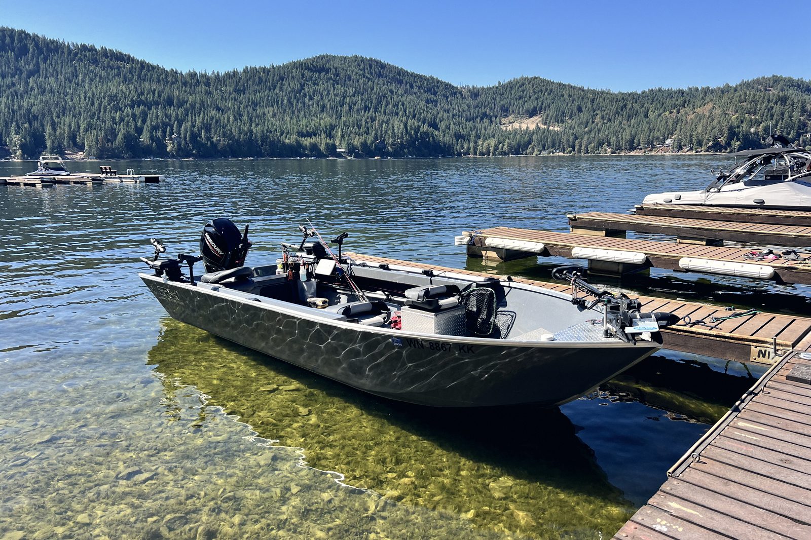 A fishing boat tied at a dock, rigged and ready for an early start.